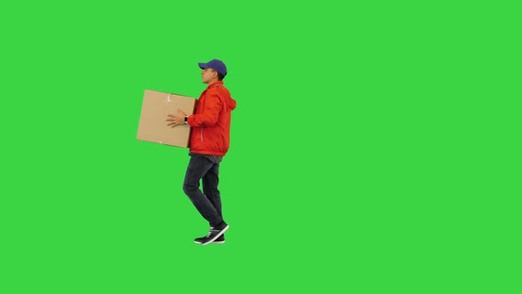 Courier in a Red Uniform Carrying a Box on a Green Screen Chroma Key