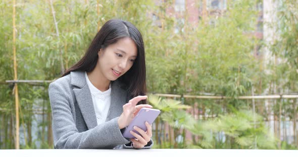 Businesswoman Using Mobile Phone Over Green Background