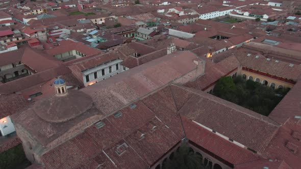 Daytime 4k drone aerial footage over Spanish colonial houses from the center of Cusco City, Peru dur