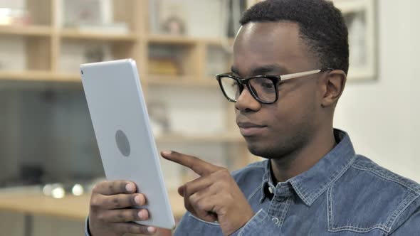 Afro-American Man Browsing on Tablet