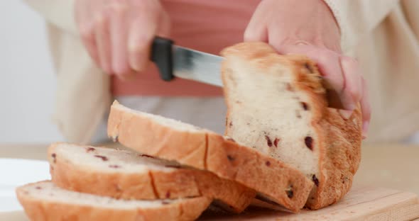 Woman cutting bread