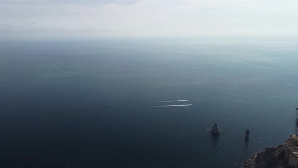 Aerial View From Above on Calm Azure Sea and Volcanic Rocky Shores