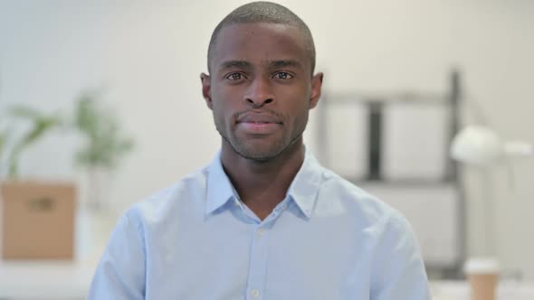 Portrait of African Man Looking at Camera in Office