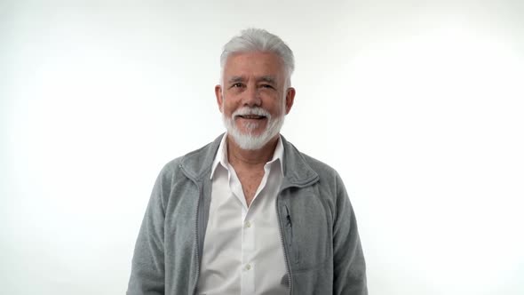 A Bearded Elderly Pensioner Man Shows Positive Smiling Emotions on a White Background