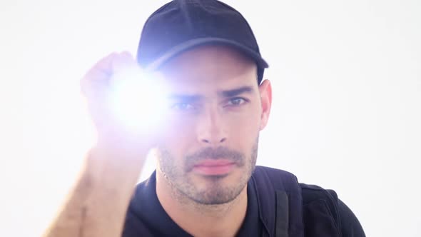 Security guard holding torch on white background