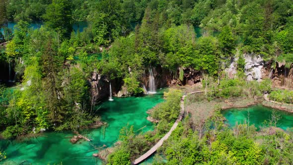 Emerald green water of Plitvice Lakes National Park in Croatia, Europe. Drone approaching waterfalls