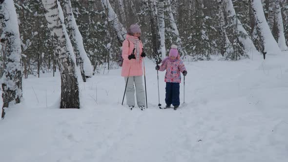 Little Girl with Mother Cross Country Skiing