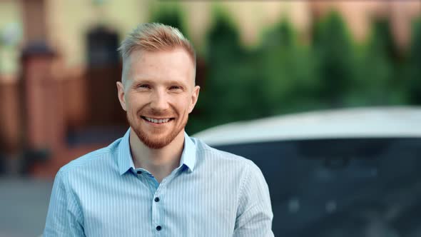 Portrait of Smiling Handsome Young European Guy Posing Looking at Camera Medium Closeup