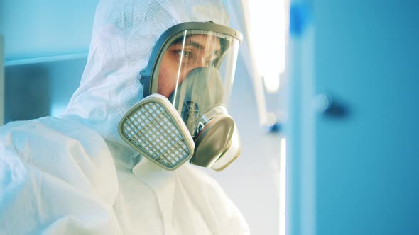 Male Specialist Wearing a Hazmat Suit in a Laboratory