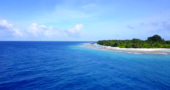 Wide above copy space shot of a paradise sunny white sand beach and aqua blue water background in co