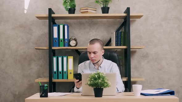Young Man Doing Paperwork in Office