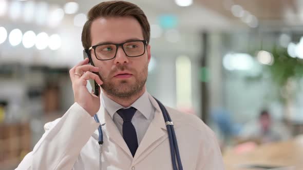 Portrait of Male Doctor Talking on Smartphone