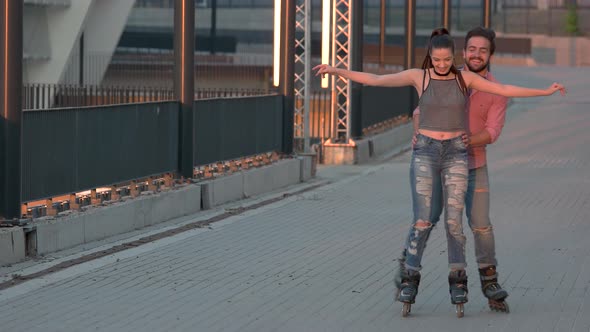 Man and Woman Are Rollerblading.