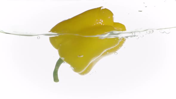 Fresh Water Splash on Yellow Sweet Pepper Isolated on White