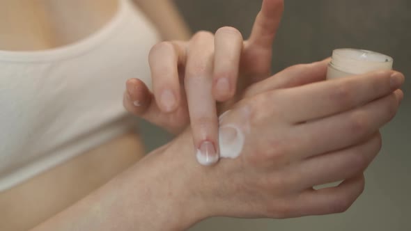 A Woman Smears a Hand Cream Closeup