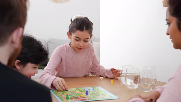 Family Playing with Board Game at Home