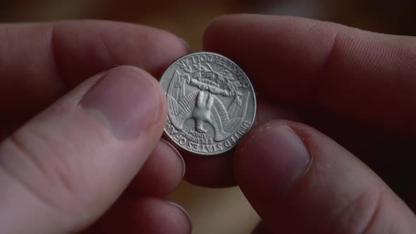 Coin is flipped in the air by hand of man in coin toss 21