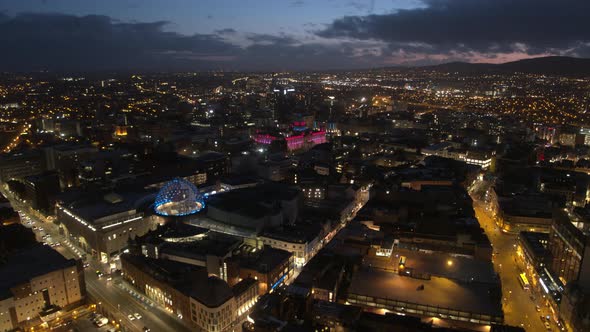 Aerial flyover of Belfast City Centre and Lagan River at night