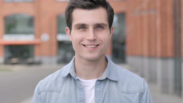 Portrait of Smiling Young Man Outside Building