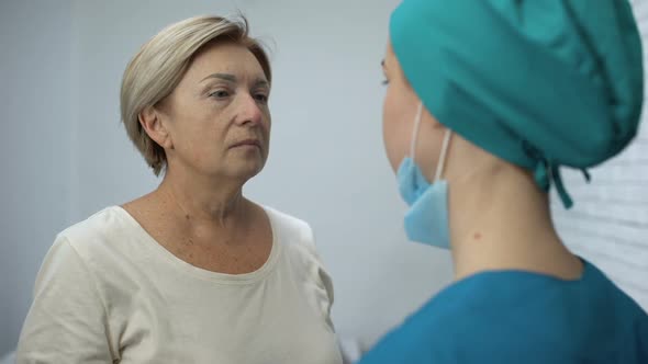 Nurse Telling Mature Patient Shocking News, Terrified Woman Crying Hysterically