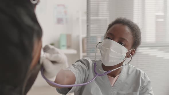 Doctor Using Stethoscope on Unrecognizable Dog