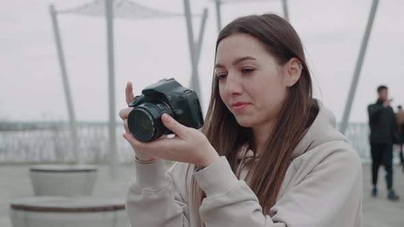 Cute Woman Photographer Making Photo Outside on the Terrace