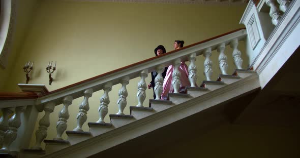 A Couple From 18Th Century Is Walking Down the Stairs at the Ball, Talking, 