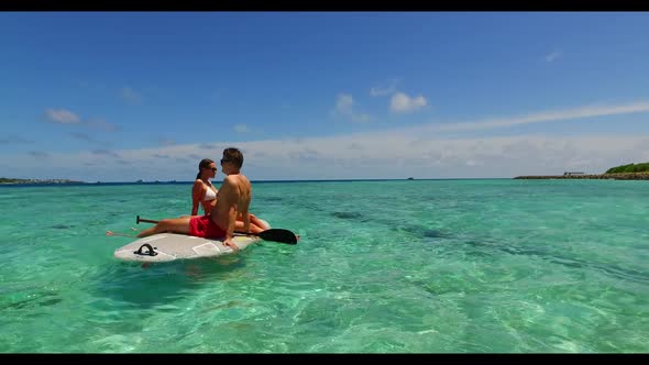 Teenage lovers posing on exotic bay beach adventure by clear lagoon with white sand background of th