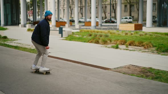 Cool Man Enjoying a Ride on Skateboard