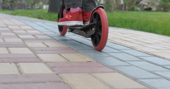 Child with scooter on road.