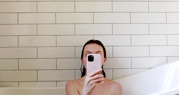 Woman Using Smartphone in Bathtub