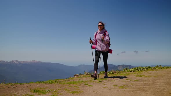 Woman Mountain Hiker with Trekking Poles