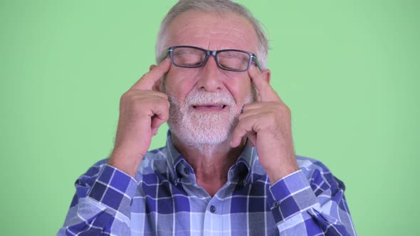 Face of Stressed Senior Bearded Hipster Man Having Headache