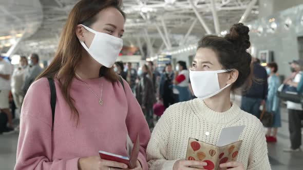 People in Protective Mask Staying in Queue for Boarding on Plane. Two Women in Medical Masks