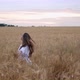 A Young Girl Happily Walking in Slow Motion Through a Field Touching with Hand Wheat Ears Beautiful - VideoHive Item for Sale