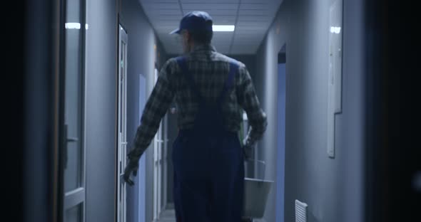 Janitor Cleaning a Corridor