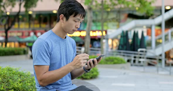 Man using smart phone in city