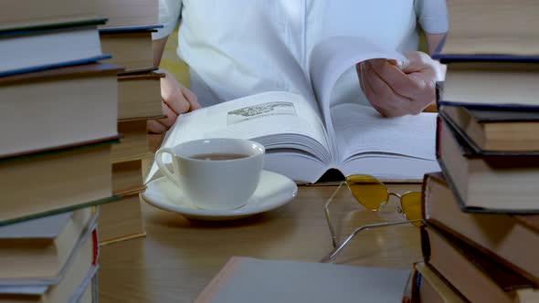 Male Hand Flipping Through the Pages of a Book Closeup