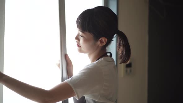 A woman cleaning the screen door