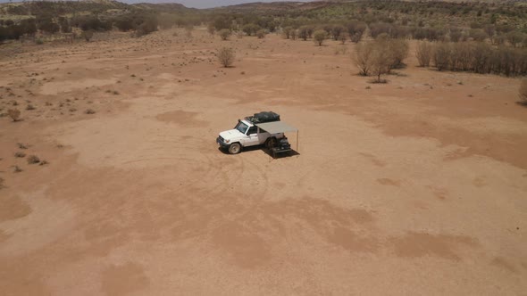 Aerial view of couple relaxing on outback road trip.