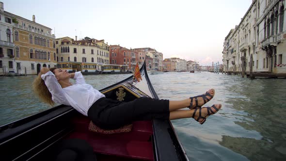 Girl Resting and Relaxing in Venice on Gondole Ride Romance in Boat on Travel Vacation Holidays