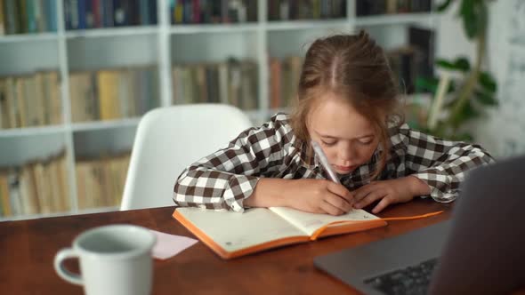 Closeup Top View of Smart Primary Child School Girl Doing Homework Writing Notes in Paper Notebook