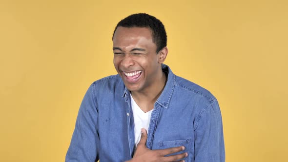 Laughing Happy African Man Yellow Background