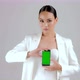 Beautiful Asian businesswoman showing smartphone with green screen - VideoHive Item for Sale