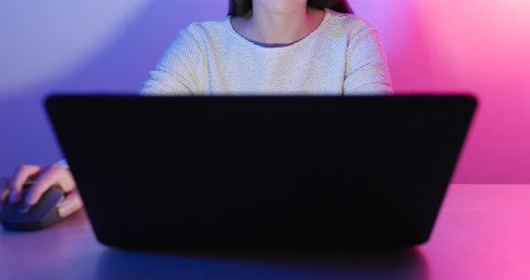 Woman Using Notebook Computer Under Cyber Lighting Color