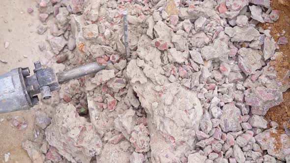 Effective Destruction of a Concrete Wall with a Jackhammer Closeup in Slow Motion