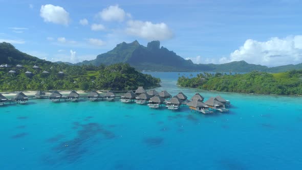 Aerial drone view of a luxury resort and overwater bungalows in Bora Bora tropical island