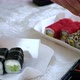 The Process of Eating Sushi on an Embroidered Blanket on the Bed - VideoHive Item for Sale
