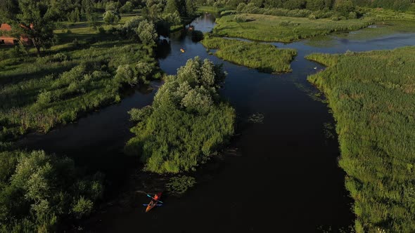 Top View of the Svisloch River Kayakers Floating on the River in the City's Loshitsky Park at Sunset