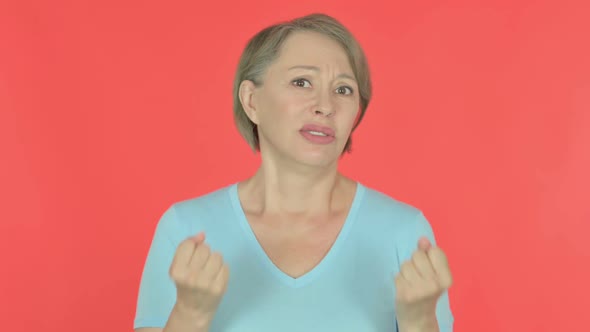 Disappointed Old Woman Reacting Loss on Red Background